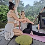 Ecuadorian Amazon: Parrots, Piranhas, and Peace 31 Woman adjusting other woman in yoga