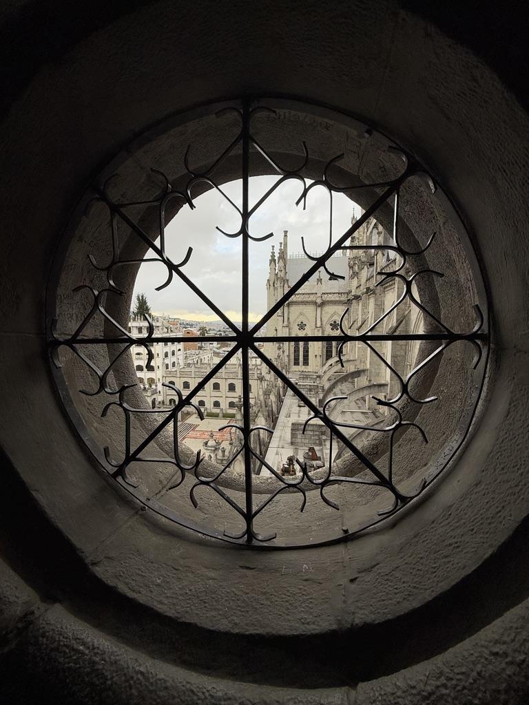 Basilica del Voto Nacional city as seen through a round window