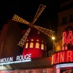 48 Hours in Paris: The Perfect 2-Day Itinerary for First-Timers 21 Brightly illuminated Moulin Rouge windmill in Paris at night.