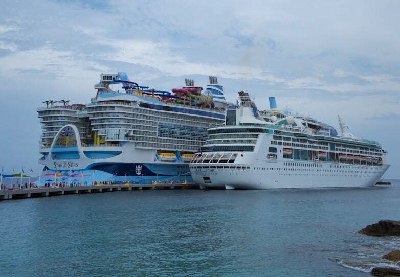 Photo by Arian Fernandez Two large cruise ships docked in the scenic Bahamas, showcasing luxury sea travel.