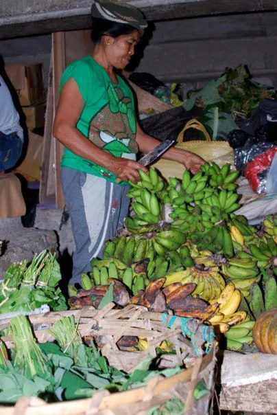 Photo of a woman cutting some bananas