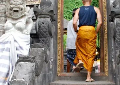 Man in sarong entering temple