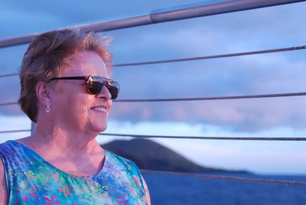Photo of Jennifer's mother wearing shades at a boat