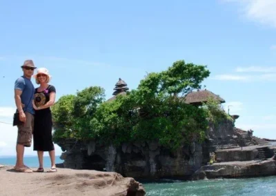 Photo of Jennifer and her husband in front of island temple in Bali