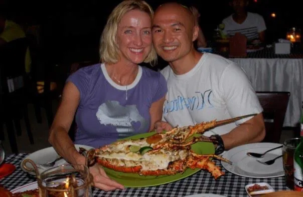 Photo of Jennifer and her husband with a huge lobster at Jimbaran Bay
