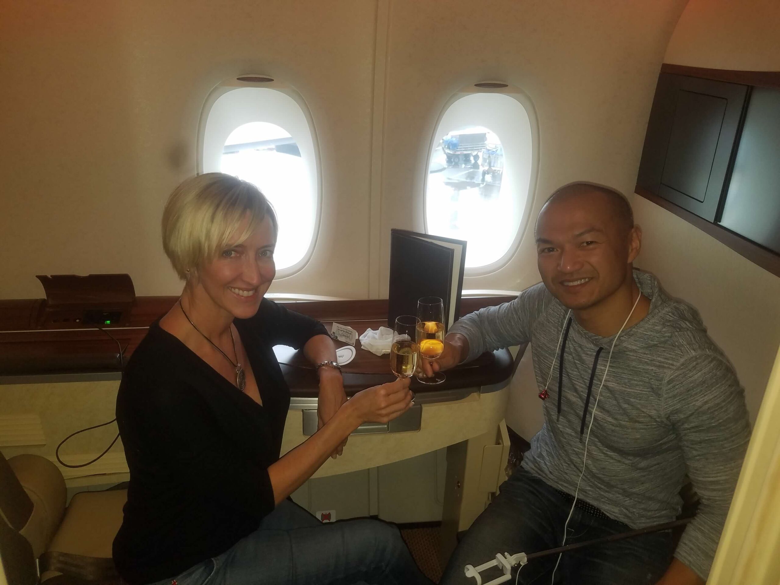 Jen and Vuong toasting in Singapore suite