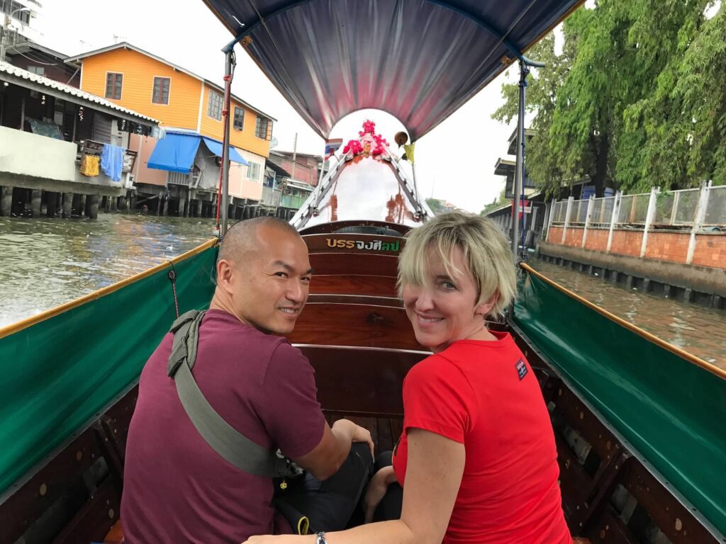 Jen and Vuong on a boat in Bangkok, Thailand