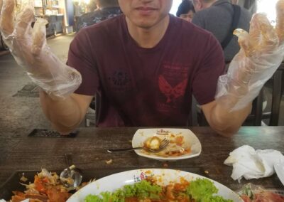 Man on a mission with gloves about to eat chili crab