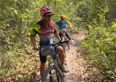 Man and woman on bikes in the woods