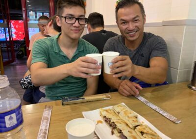 two men with water cups and donkey burgers