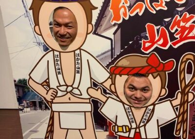 two men with heads in ninja photo op display