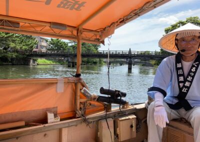 man in cone hat on boat