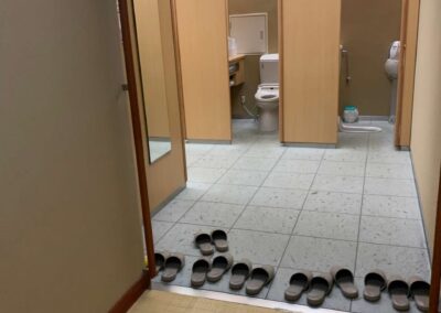 slippers lined up at restroom entrance