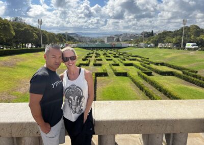 Male and female standing in front of park