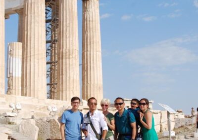 family in front of the parthenon