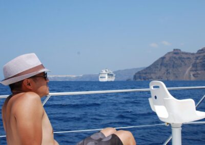 Man with fedora on boat in the sea