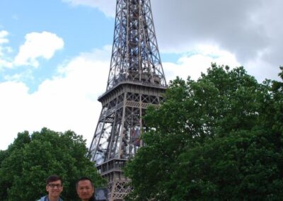 two men, some trees, and the Eiffel Tower