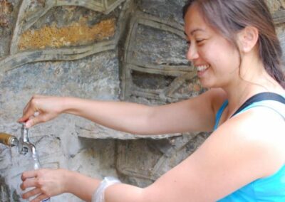 Woman getting water from tap