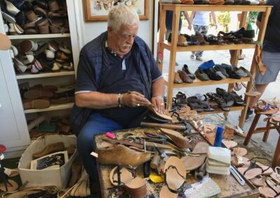 Man sitting in front of table with shoe components