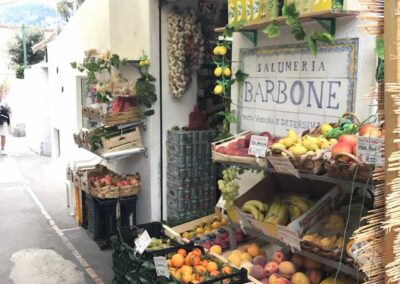 Produce outside of small sidewalk-side grocery market