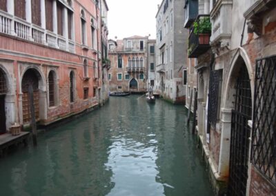 side canal with boats lined by buildings