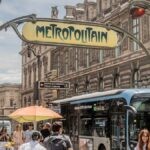Bustling Paris street scene with classic Métro signpost near Palais Royal.